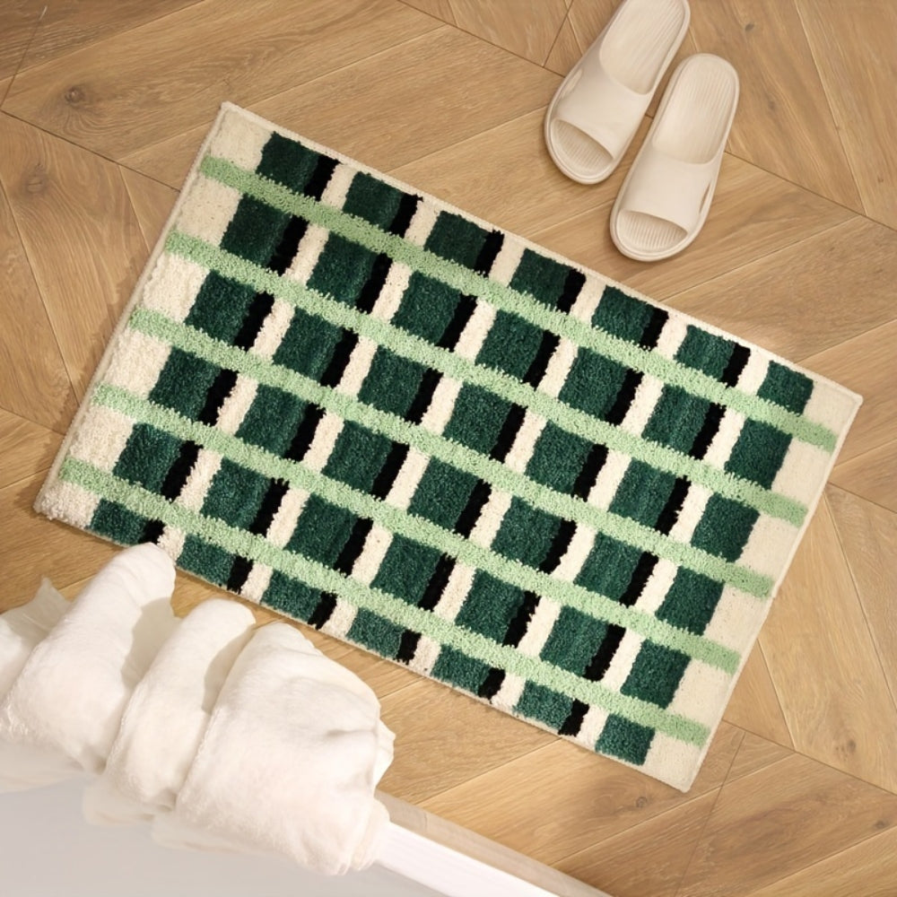 Mosegrønn badematte med geometrisk flokkmønster