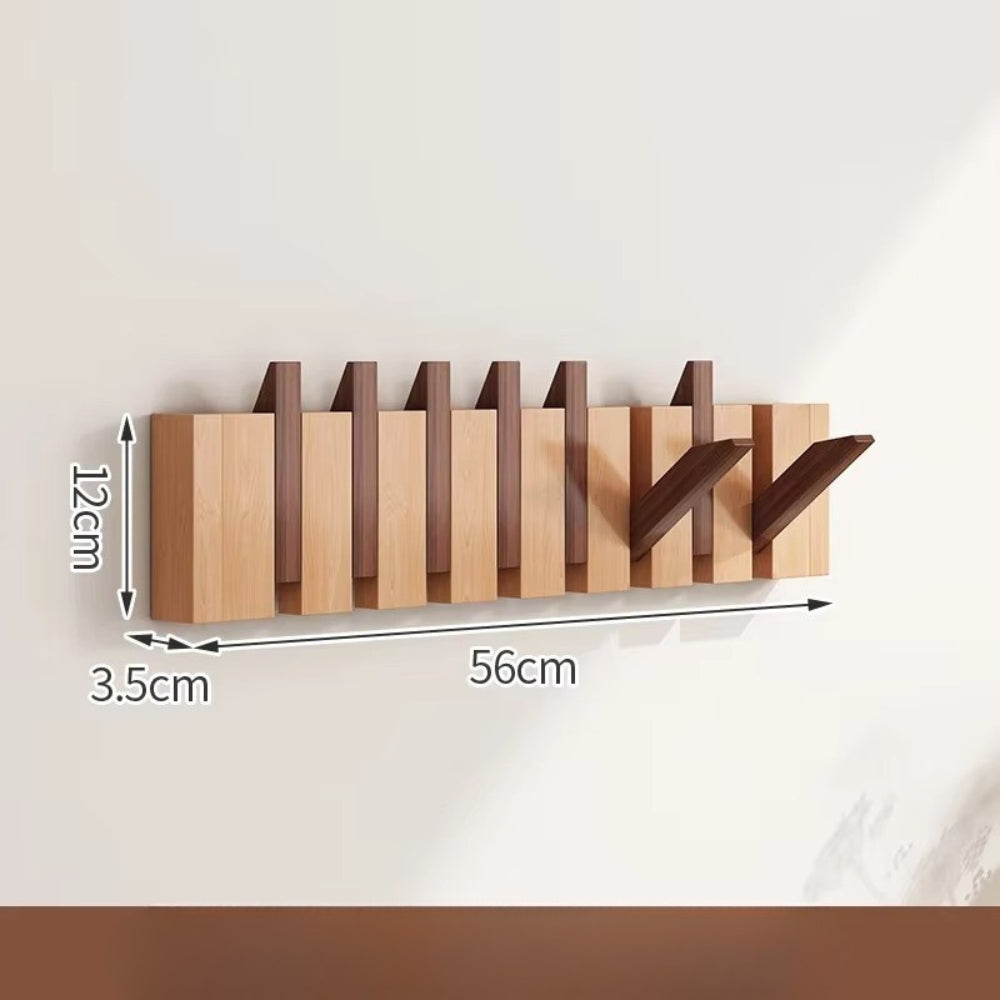 Sammenleggbar veggknagg i tre med pianodesign