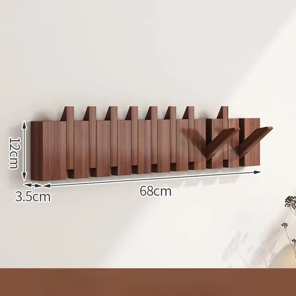 Sammenleggbar veggknagg i tre med pianodesign