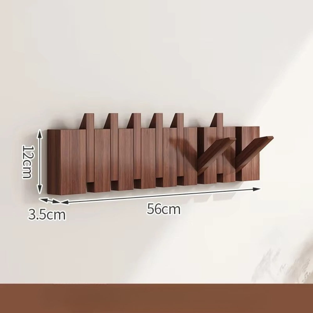 Sammenleggbar veggknagg i tre med pianodesign
