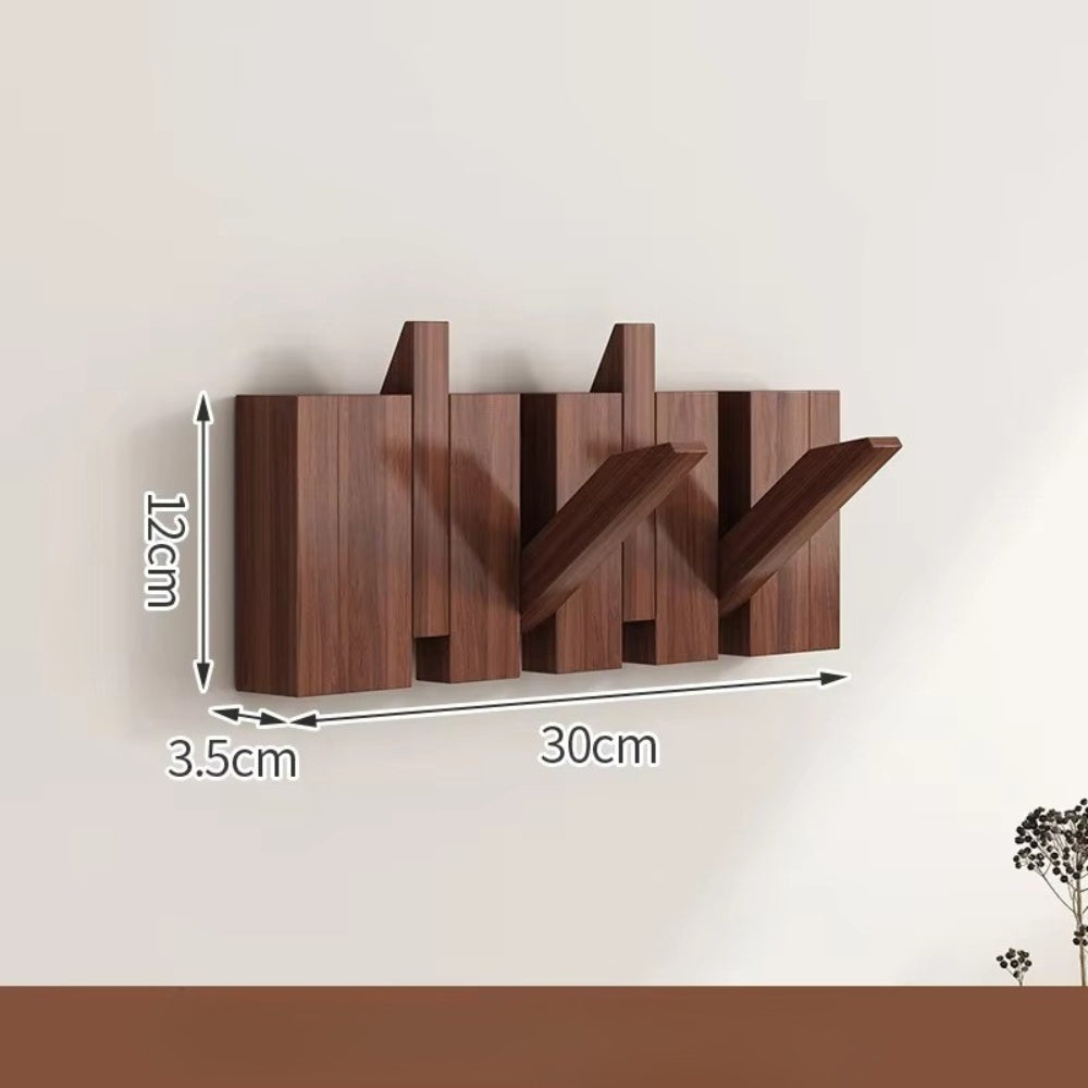 Sammenleggbar veggknagg i tre med pianodesign