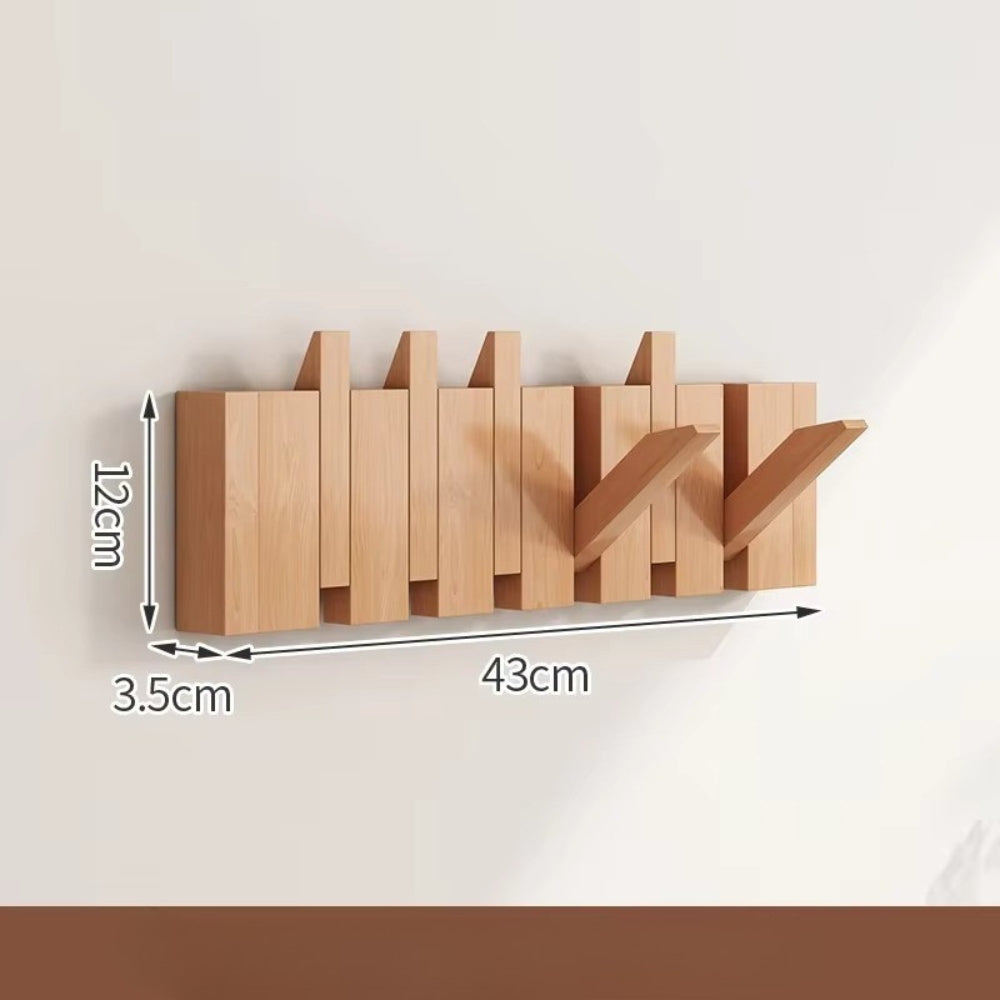 Sammenleggbar veggknagg i tre med pianodesign