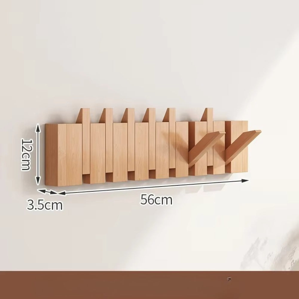 Sammenleggbar veggknagg i tre med pianodesign