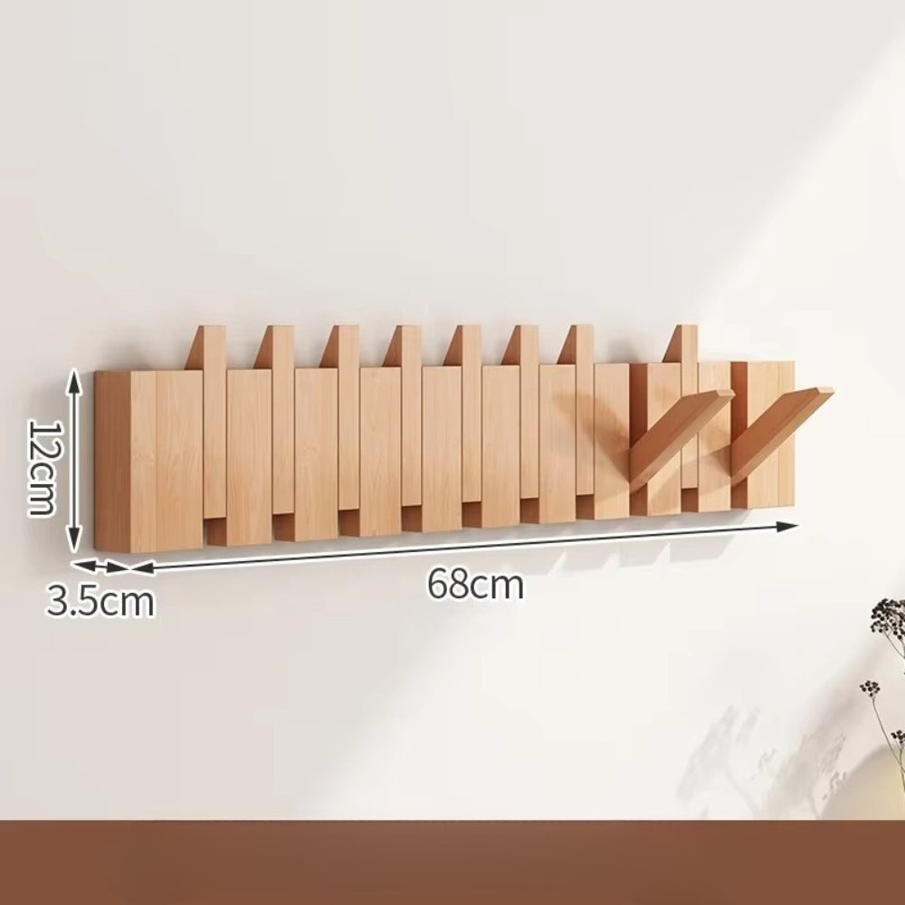 Sammenleggbar veggknagg i tre med pianodesign