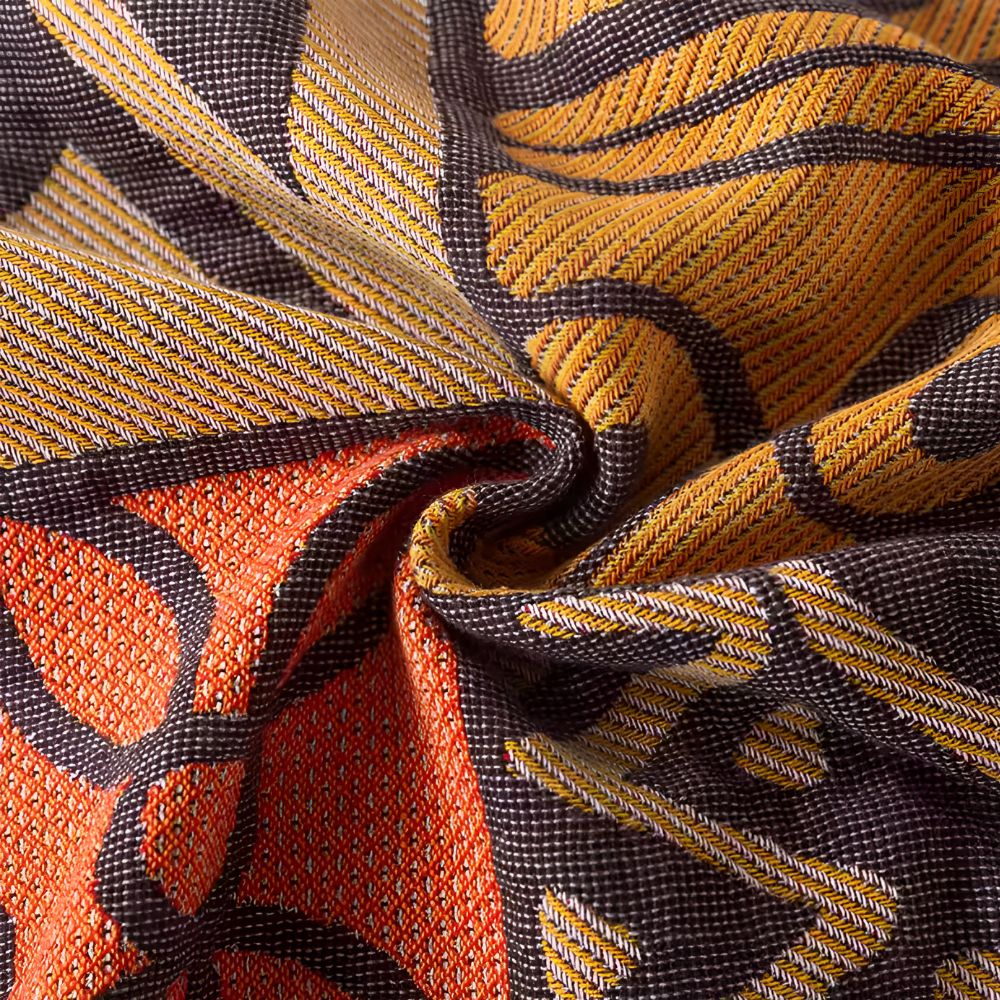 Vendbart bomullspledd med tribal patchwork og dusker