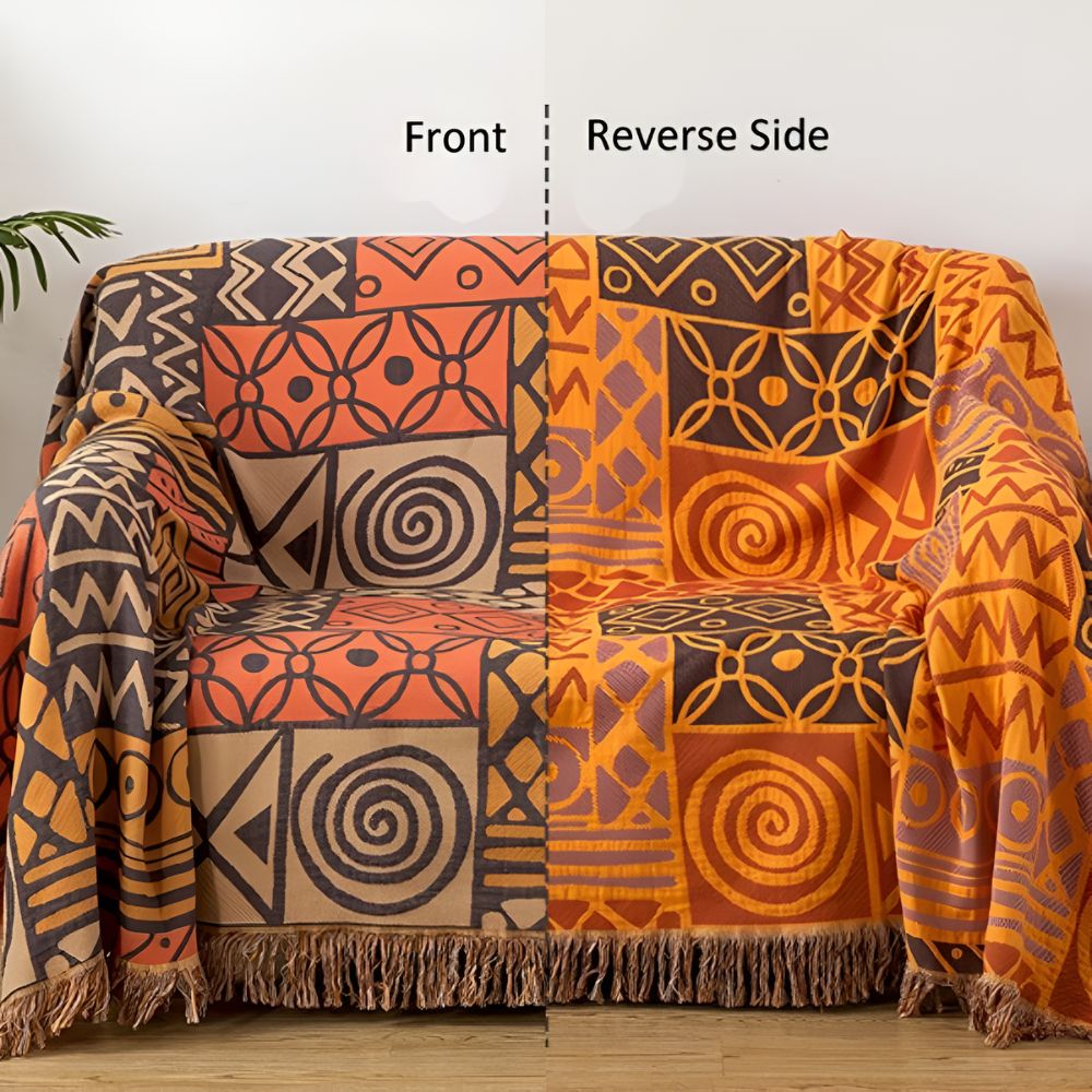 Vendbart bomullspledd med tribal patchwork og dusker