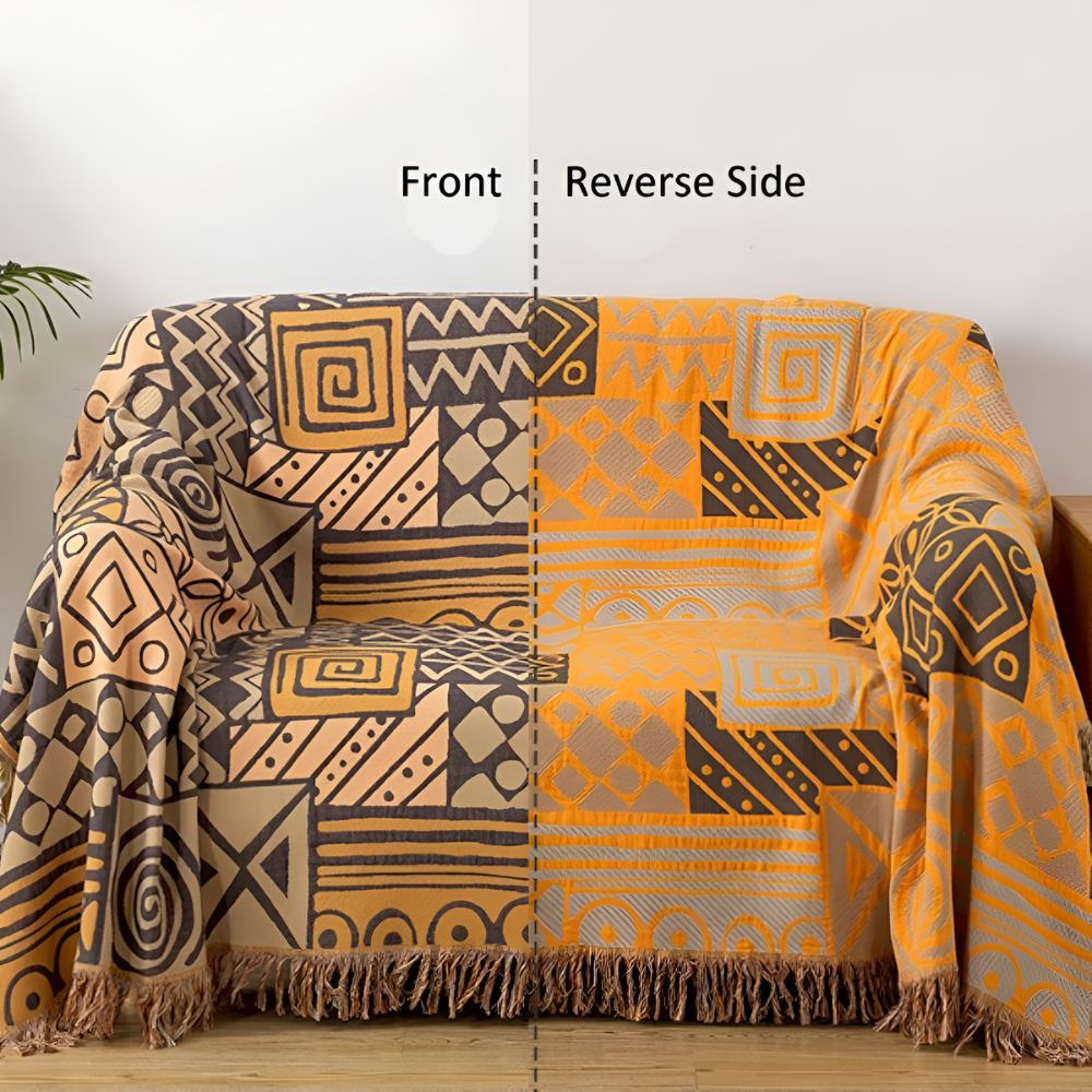 Vendbart bomullspledd med tribal patchwork og dusker